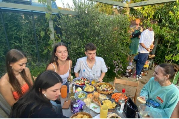 Group of friends enjoying outside at patio table